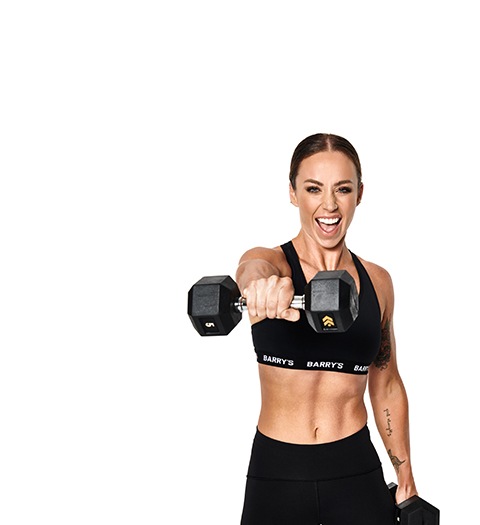 Barry's Bootcamp instructor Alicia Beveridge wearing a black sports bra and punching forward with one dumbbell.