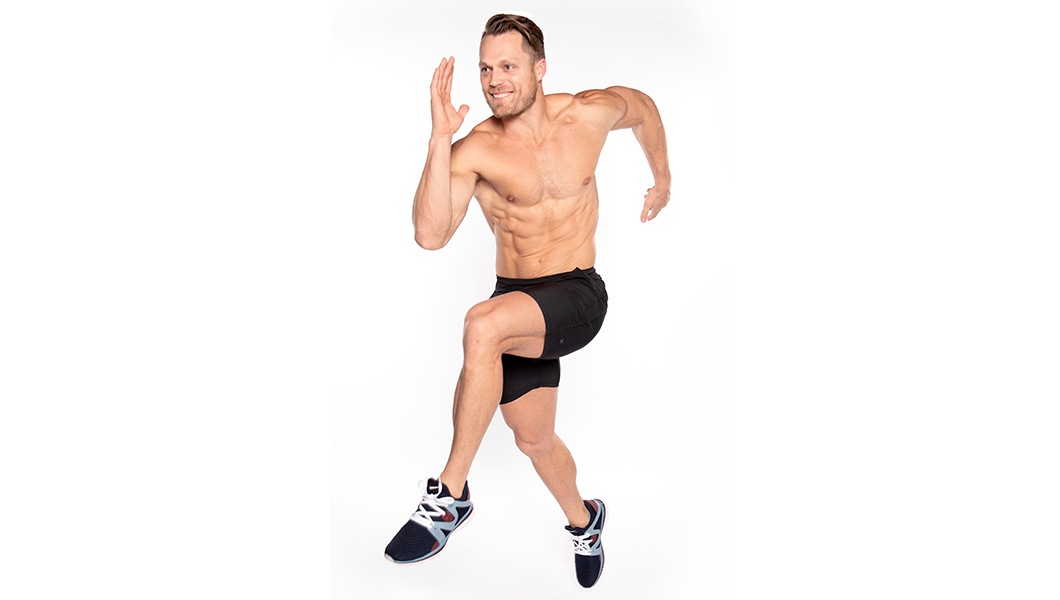 Barry's Instructor Andrew Key shirtless with black shorts in running position.