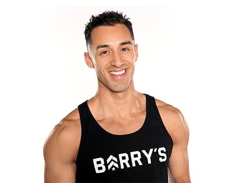 Headshot of instructor Andrew Nunez in black Barry's Bootcamp tank top smiling on white background
