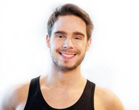 Headshot of instructor Benjamin Larsen in black tank top smiling on white background