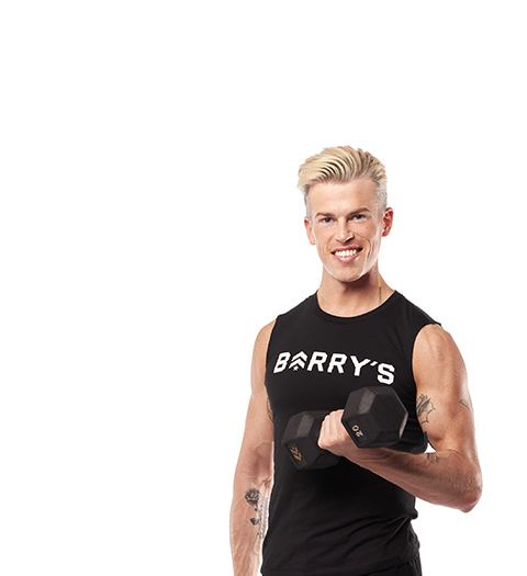 Barry's Bootcamp instructor Brendan Sorichetti standing against a white background doing a bicep curl with one arm.