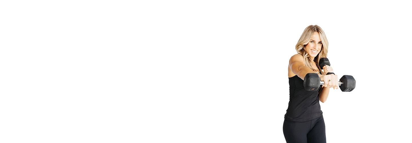 Barry's Bootcamp instructor Emma Elving against a white background punching with dumbbells.