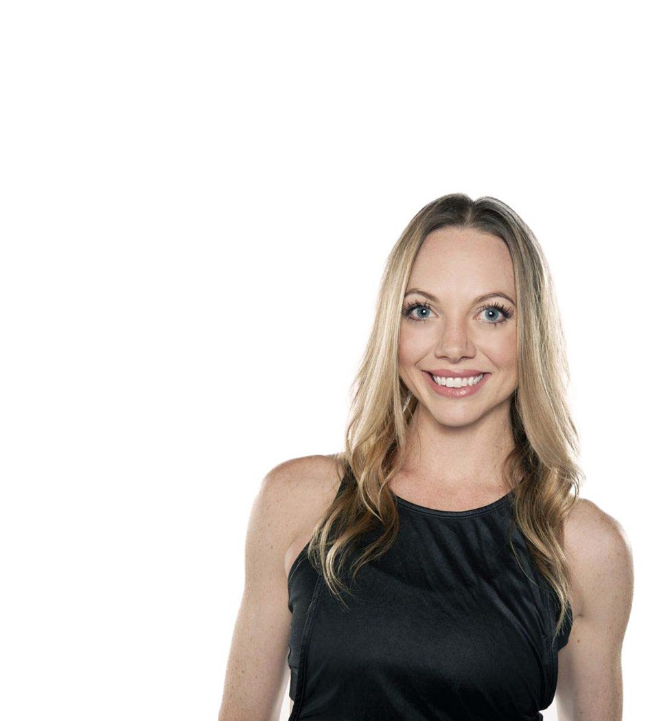 Barry's instructor standing confidently wearing a black tank top against a white background, ready for the next workout challenge.