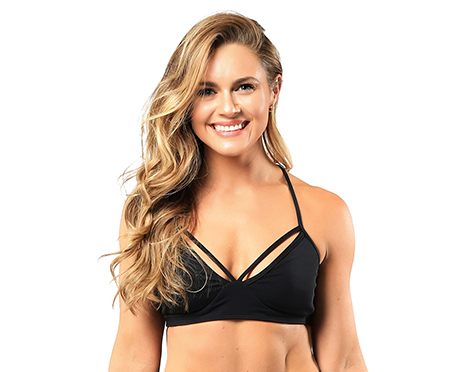 Headshot of instructor Holly Keskey-Koester in black sports bra smiling on white background