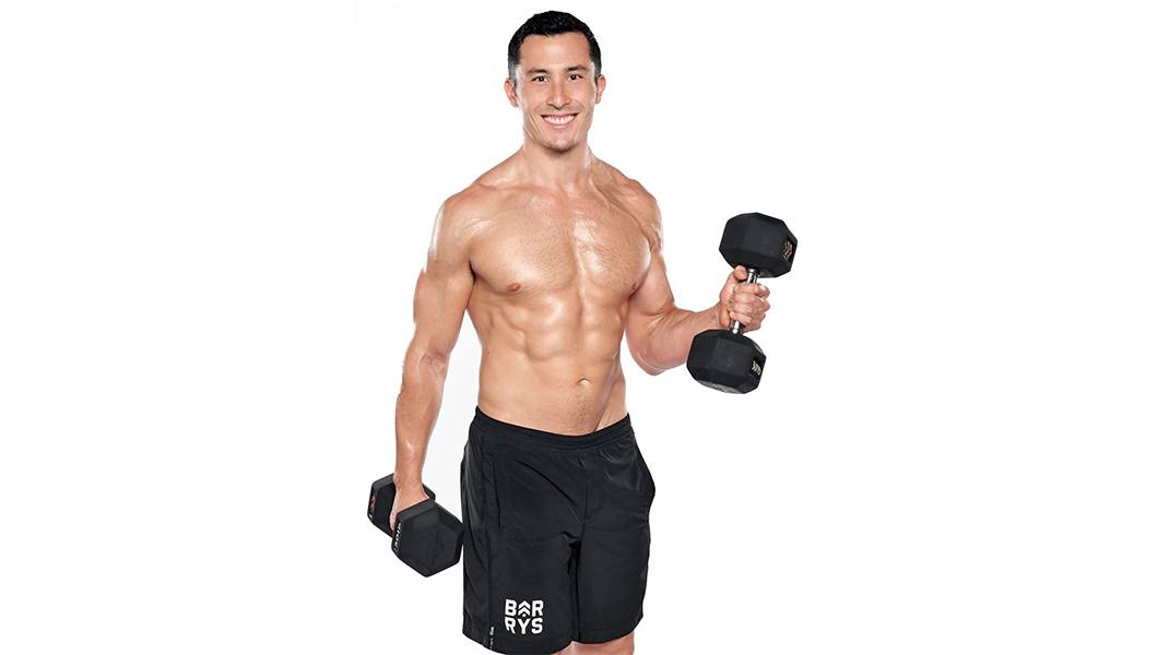 barry's instructor Jeffrey Langewisch shirtless posing with dumbbells