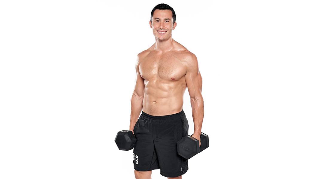 barry's instructor Jeffrey Langewisch shirtless posing with dumbbells