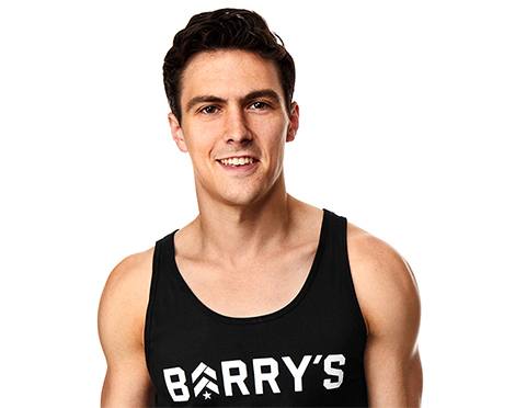Headshot of instructor Jimmy Nicholas in black Barry's Bootcamp tank top smiling on white background