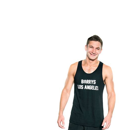 Instructor Jordan Gluck in black Barry's Bootcamp tank top smiling on white background