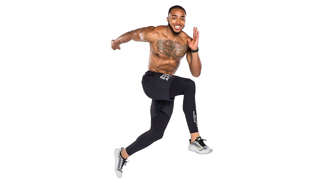 Shirtless Barry's Bootcamp instructor Justyn Solomon doing skipping exercise on white background