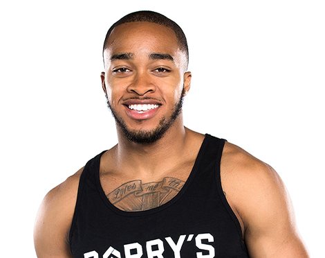 Headshot of instructor Justyn Solomon in black Barry's Bootcamp tank top smiling on white background