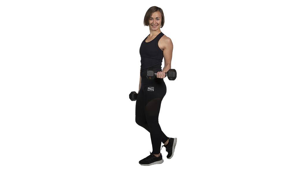 Barry's Bootcamp instructor Katariina Kivekäs in black tank top smiling while holding dumbbells on white background