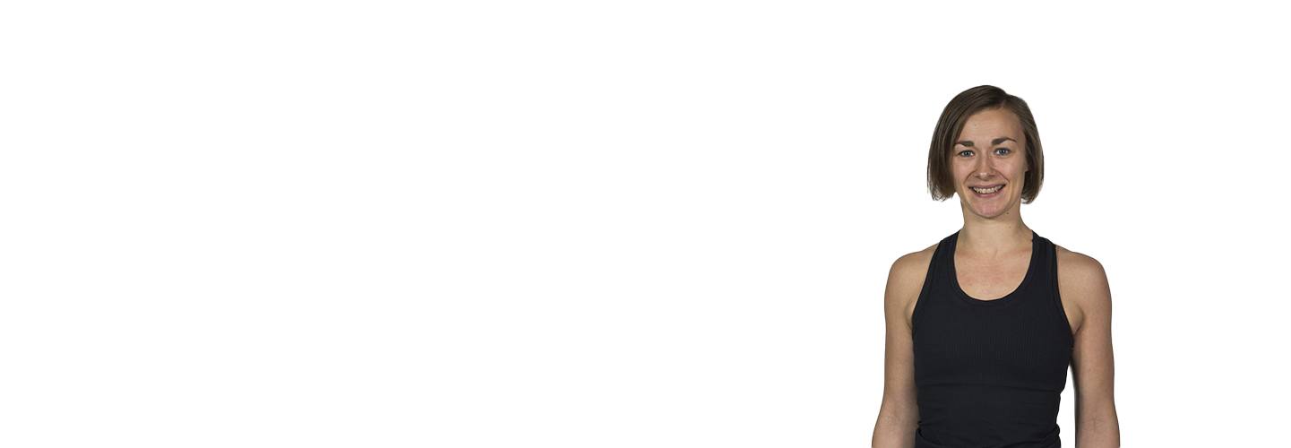 Barry's Bootcamp instructor Katariina Kivekäs in black tank top smiling on white background