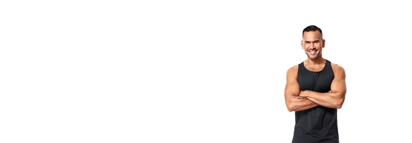 Barry's Bootcamp instructor Keoni Hudoba in black tank top smiling with arms folded over chest