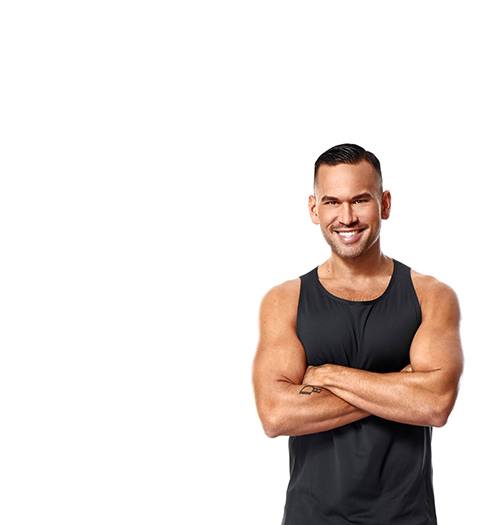 Barry's Bootcamp instructor Keoni Hudoba in black tank top smiling with arms folded over chest