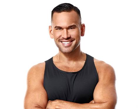 Headshot of instructor Keoni Hudoba in black tank top smiling with arms folded over chest