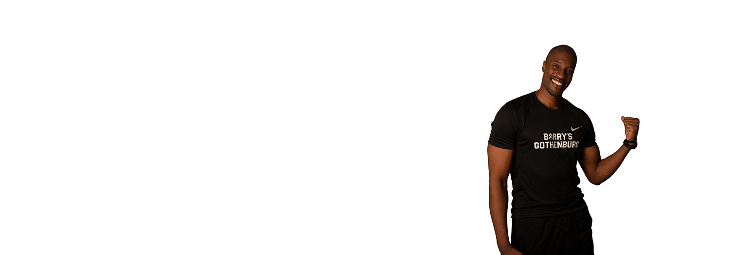 Barry's Bootcamp instructor Kevin Ukhagbe flexing his left bicep against a white background.