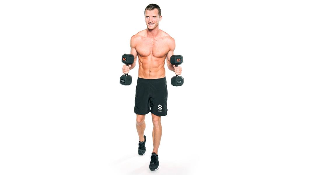 Barry's instructor Matt Conrad shirtless posing with dumbbells