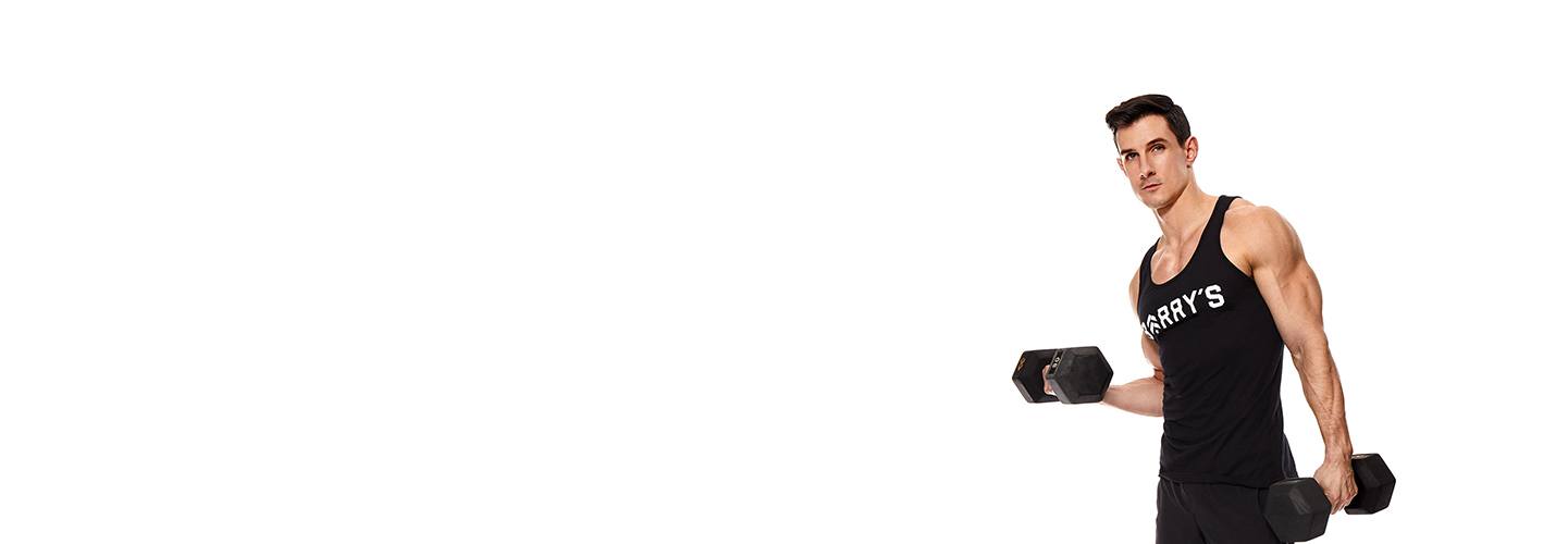 Instructor Michael Pugliese in black Barry's Bootcamp tank top holding dumbbells on white background