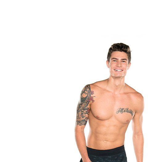 Shirtless Barry's Bootcamp instructor Nolan Zarlin smiling in front of white background