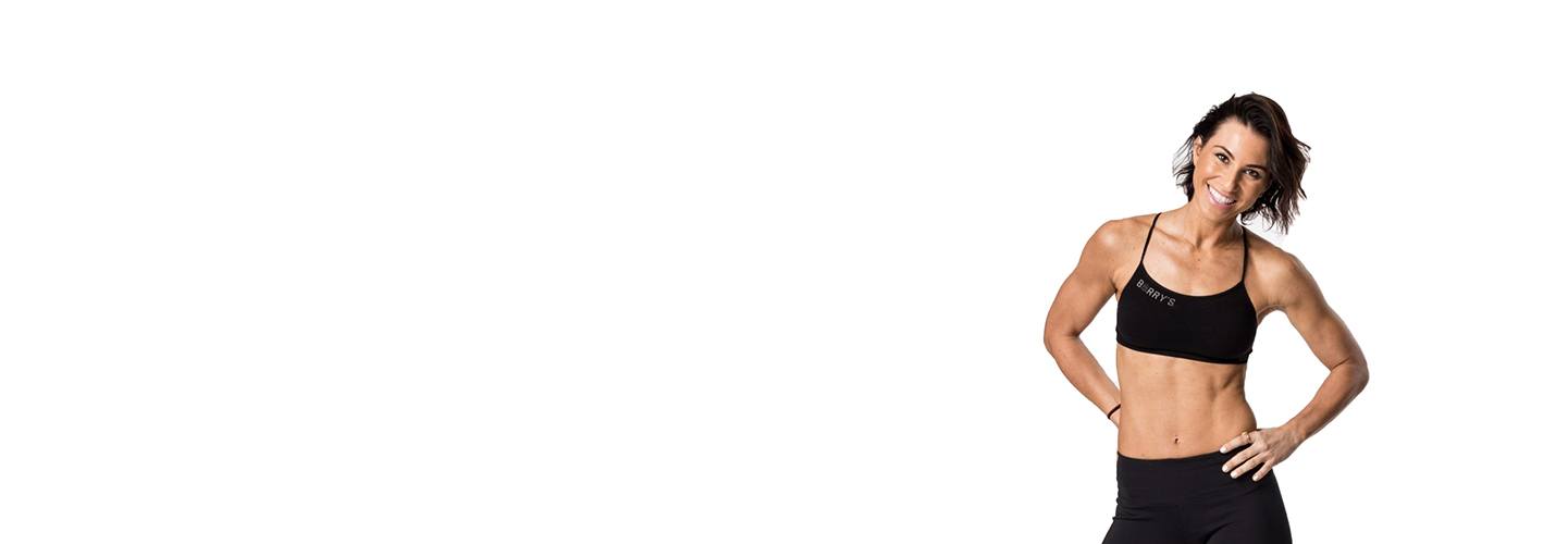 Barry's instructor Rachel Robinson wearing black sports bra with hands on hips