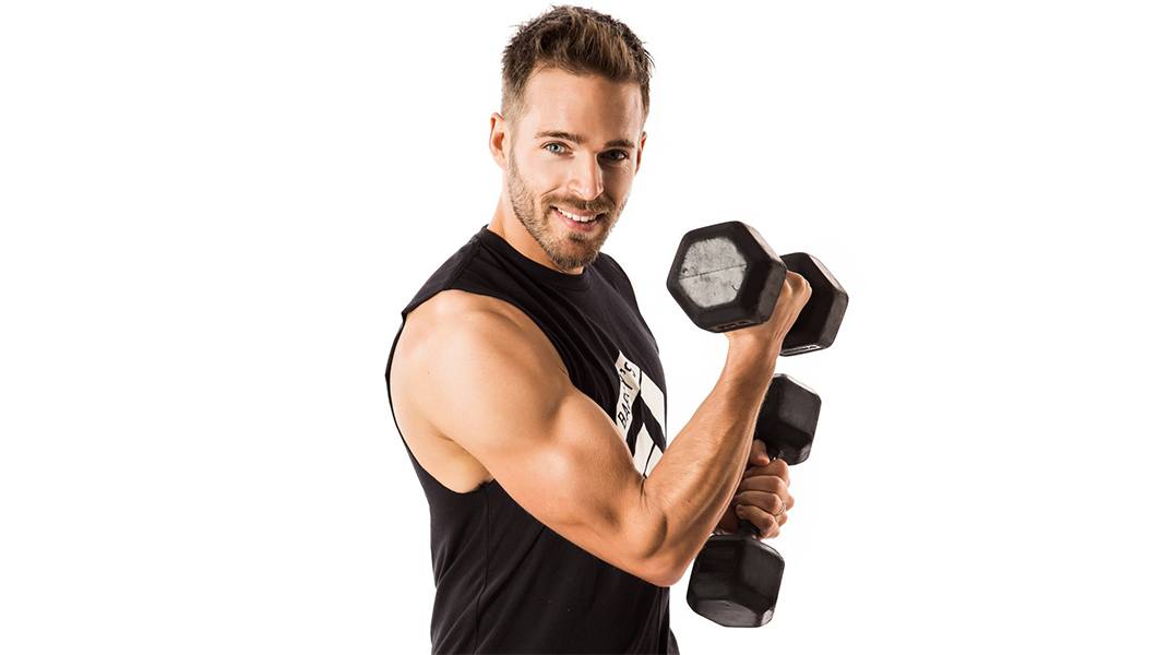 barry's instructor Sandy Macaskill wearing black tank posing with dumbbells