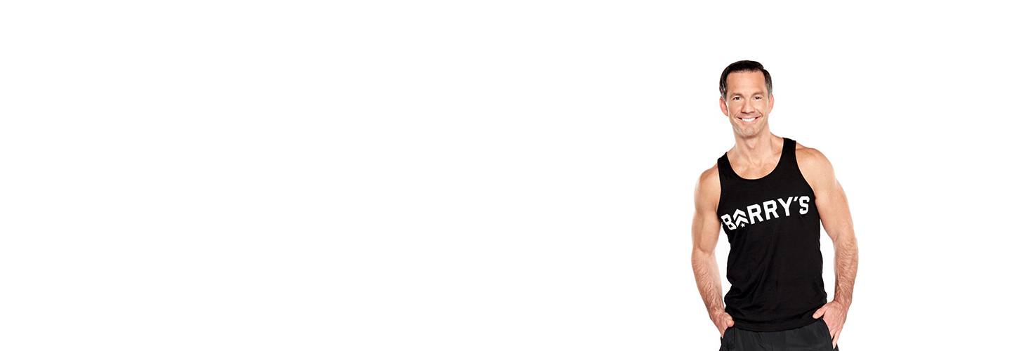 Barrys instructor Scott Haddock wearing black tank with hands in pockets