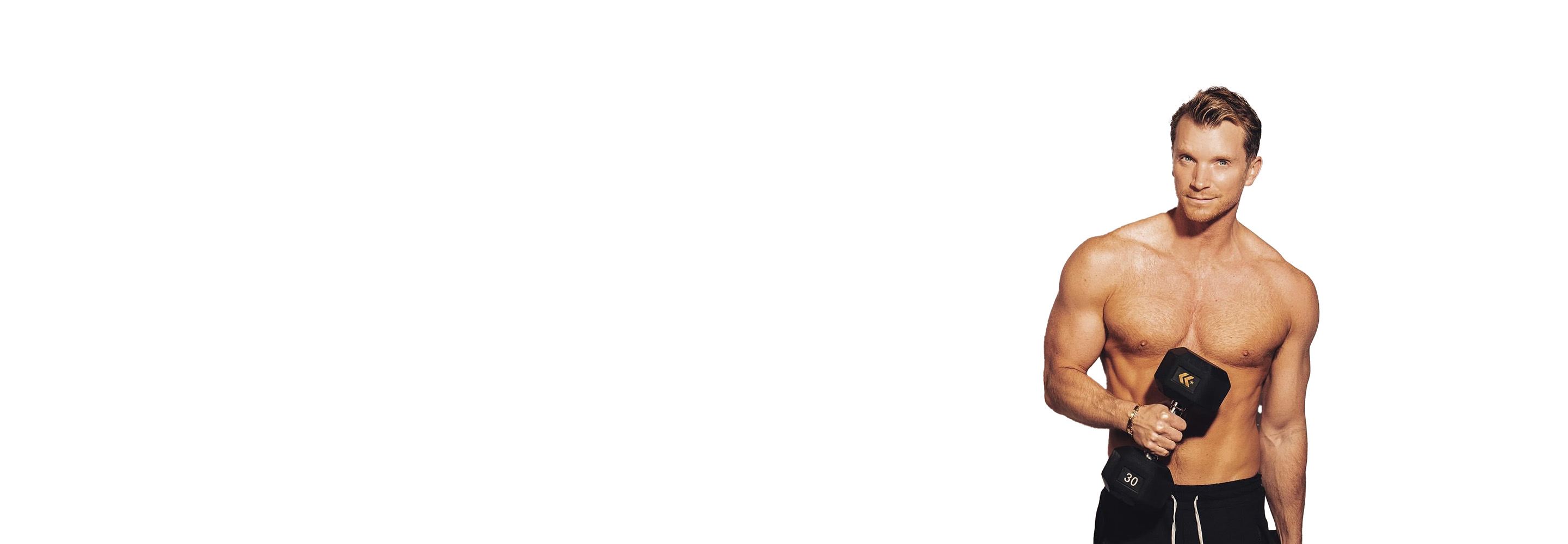 Barry's instructor shirtless lifting a weight against a white background.