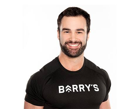 Headshot of Barry's Bootcamp instructor Ben Zerbst wearing a black Barry's t-shirt against a white background.