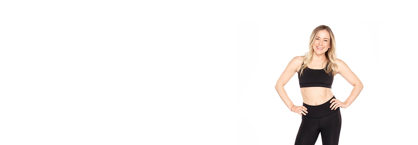 Barry's Bootcamp instructor Carly Erickson wearing a black sports bra with her hands on her hips against a white background.