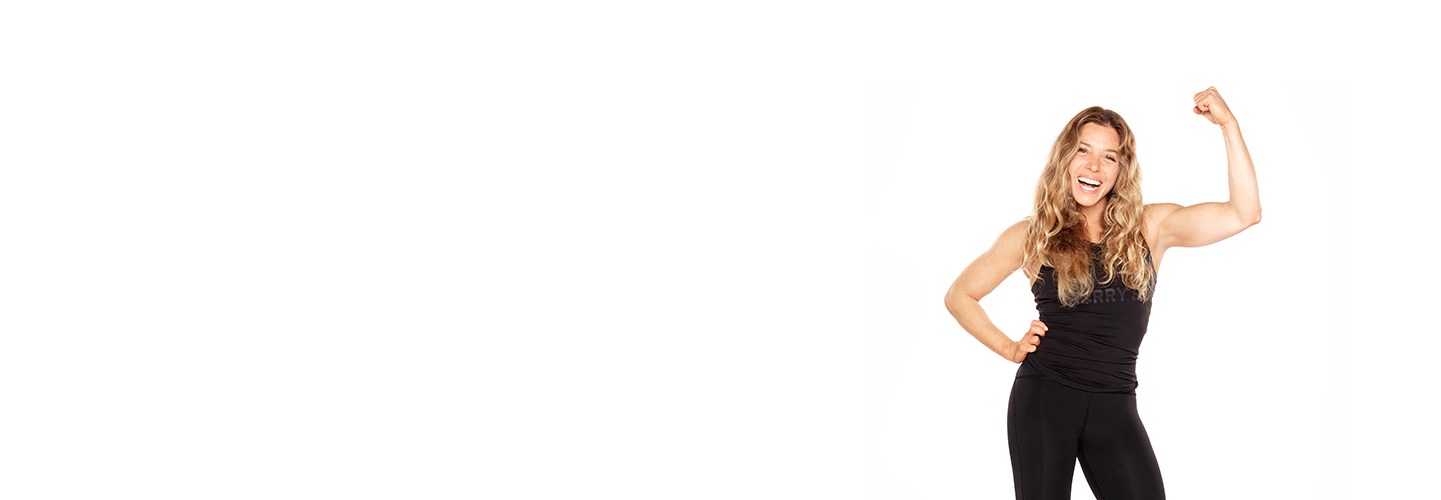 Barry's Bootcamp instructor Giorgi wearing a black sports bra punching forward with a dumbbell against a white background.