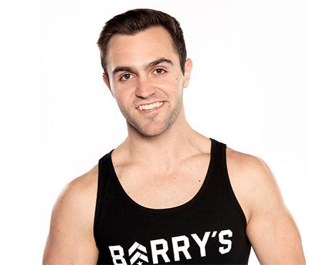Headshot of Barry's Bootcamp instructor Kael Williams wearing a black tank top with white Barry's logo.