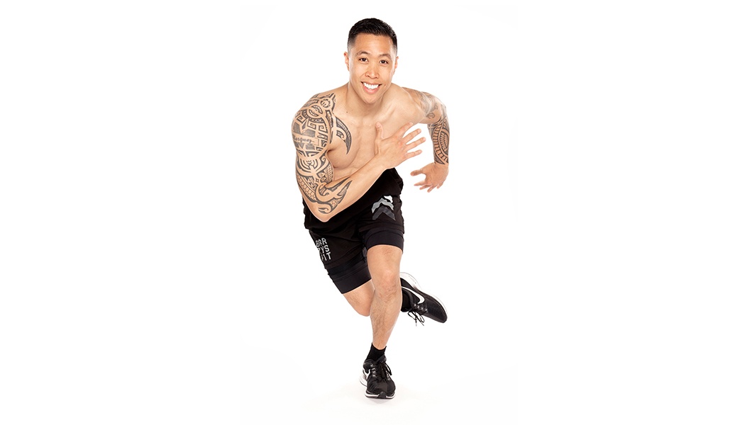Barry's Bootcamp instructor Matt Marquez shirtless doing ski-jump exercise move against a white background.