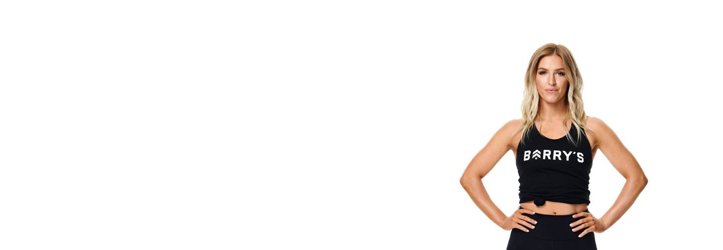 Instructor Nicole Christey in Barry's Bootcamp tank top with determined face and both hands on hips