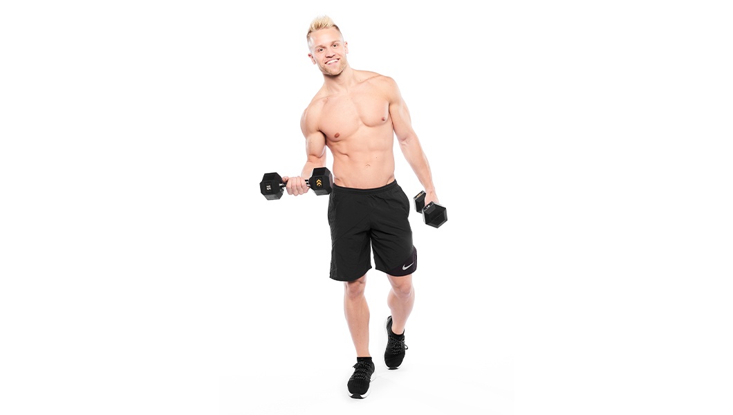 Barry’s instructor shirtless standing confidently smiling holding weights against a white background