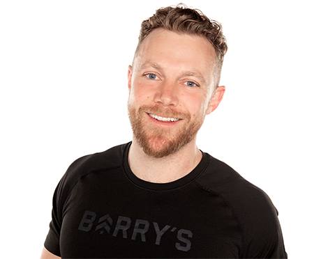 Headshot of Barry's Bootcamp instructor Tommy Killen wearing a black t-shirt against a white background.