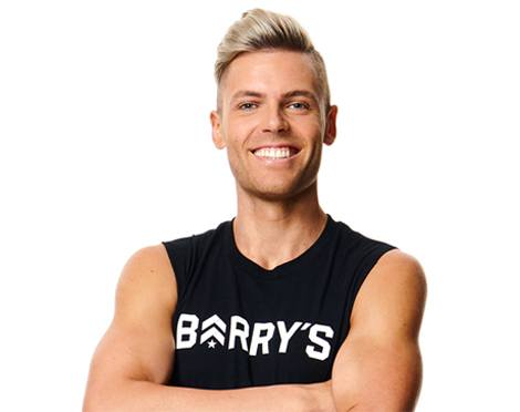 Headshot of instructor Zac Hope smiling in Barry's Bootcamp tank top on white background
