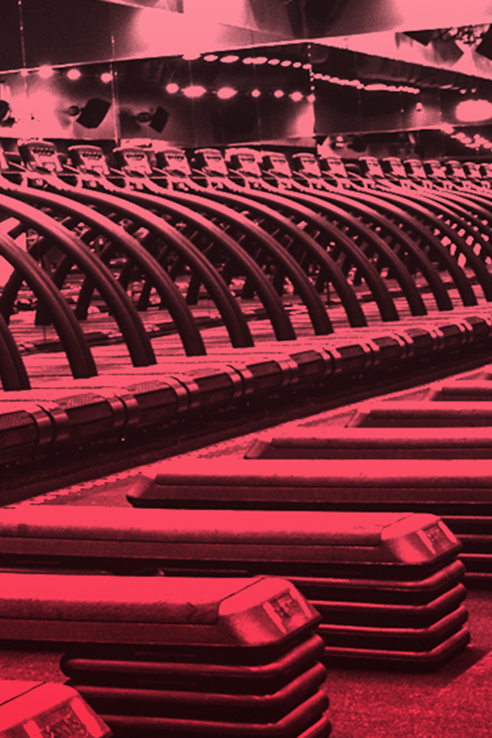 Line of treadmills in front of mirror in Barry's Bootcamp Red Room
