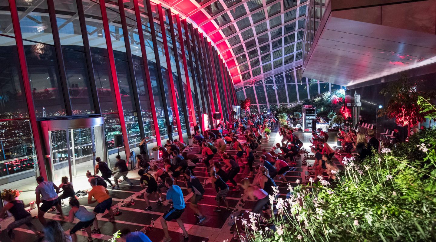 Barry's Bootcamp fitness class in London Sky Garden in front of large glass windowed wall