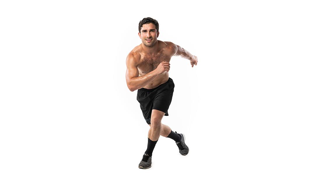 Barry's instructor shirtless running towards the camera against a white background.