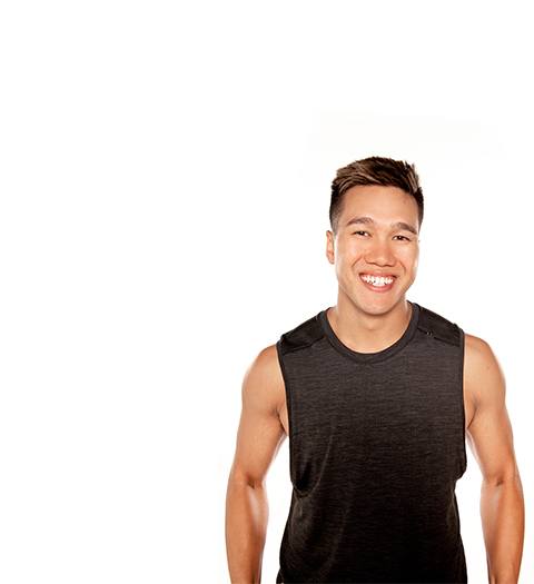 Barry's instructor standing confidently wearing a black tank top against a white background, ready for the next workout challenge.