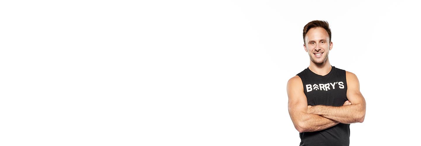 Barry's instructor standing confidently wearing a black top against a white background.