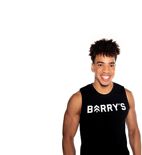 Barry's instructor standing confidently wearing a black top against a white background.
