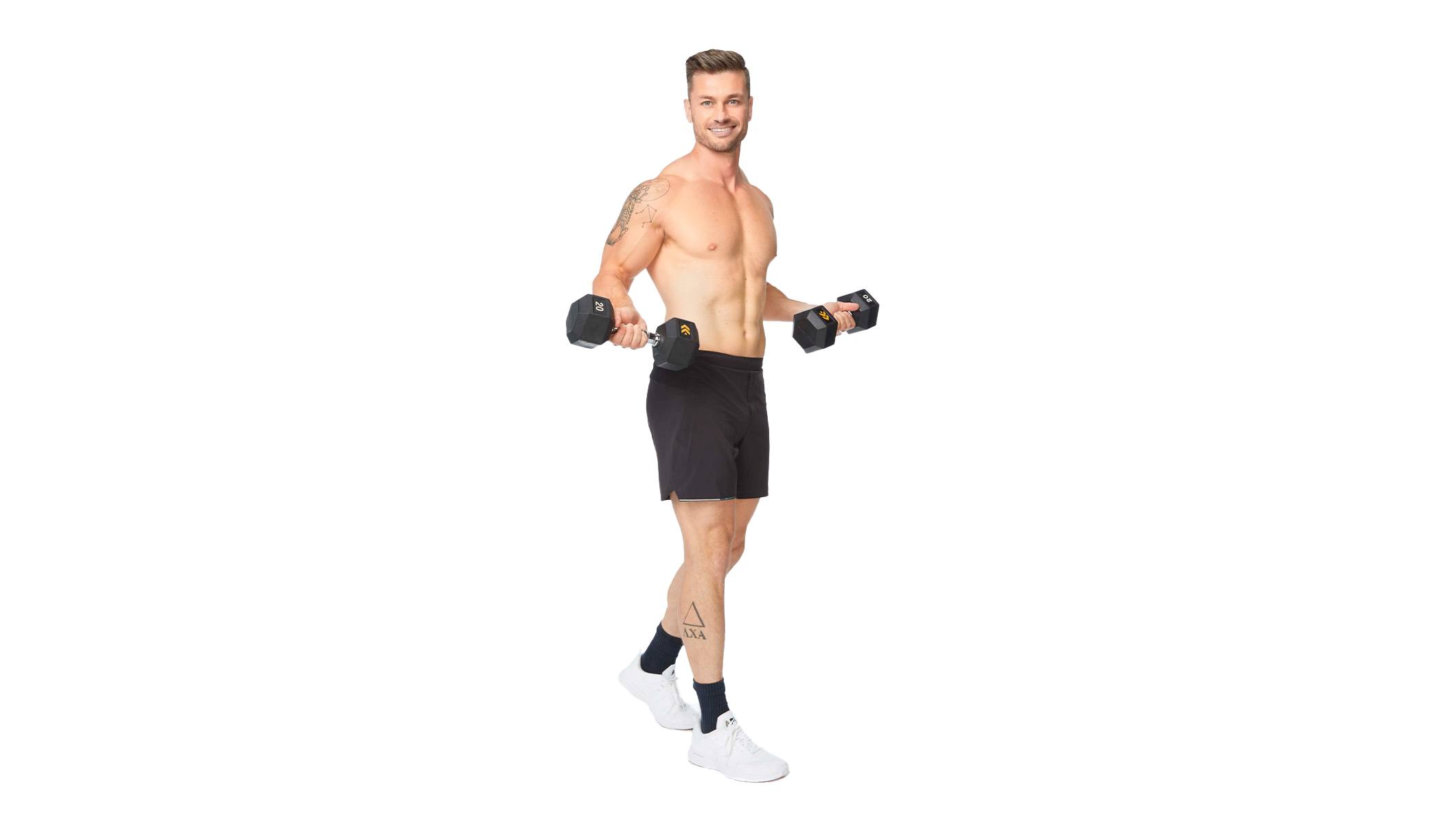 Barry's instructor standing confidently holding weights, wearing a black tank top against a white background, ready for the next workout challenge.