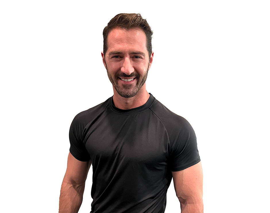 Barry's instructor standing confidently wearing a black top against a white background.