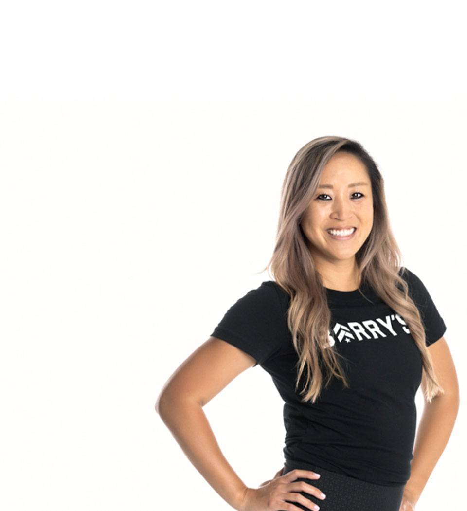 Barry's instructor standing confidently wearing a black top against a white background.