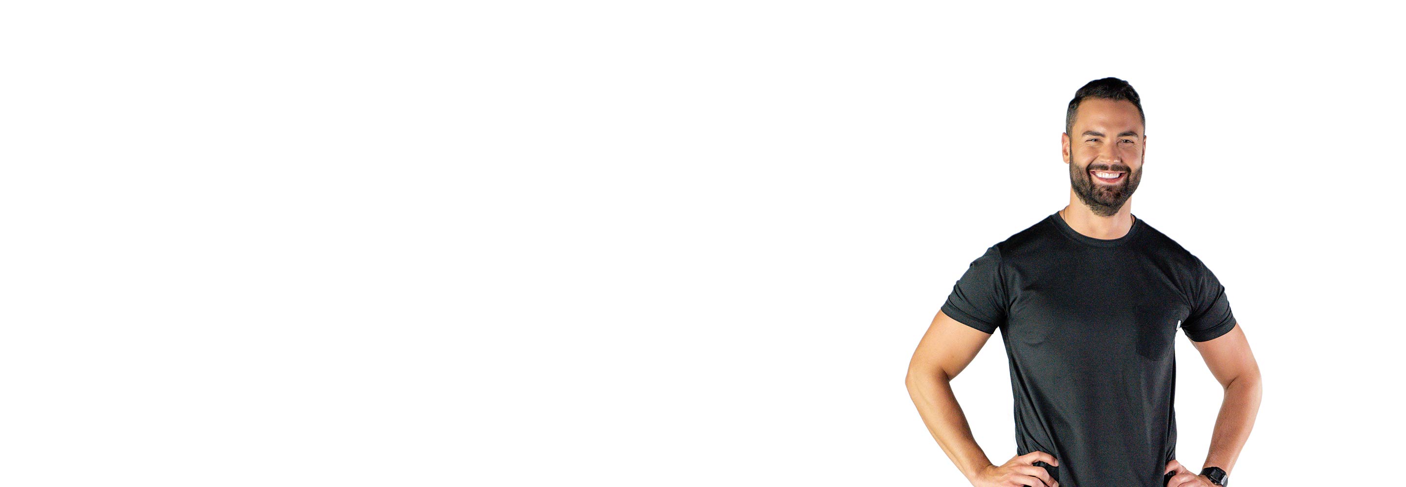 Barry’s instructor wearing a black top standing confidently smiling against a white background