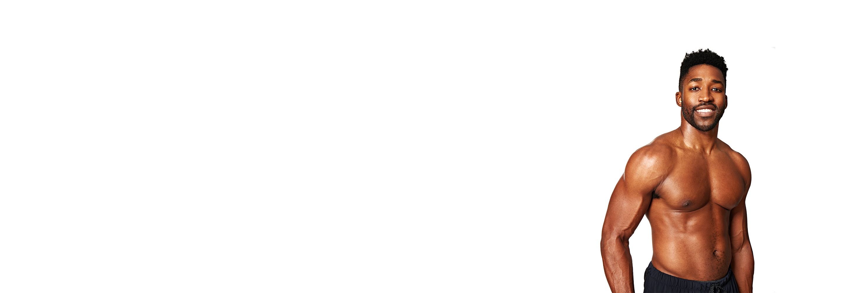 Barry’s instructor shirtless standing confidently smiling against a white background