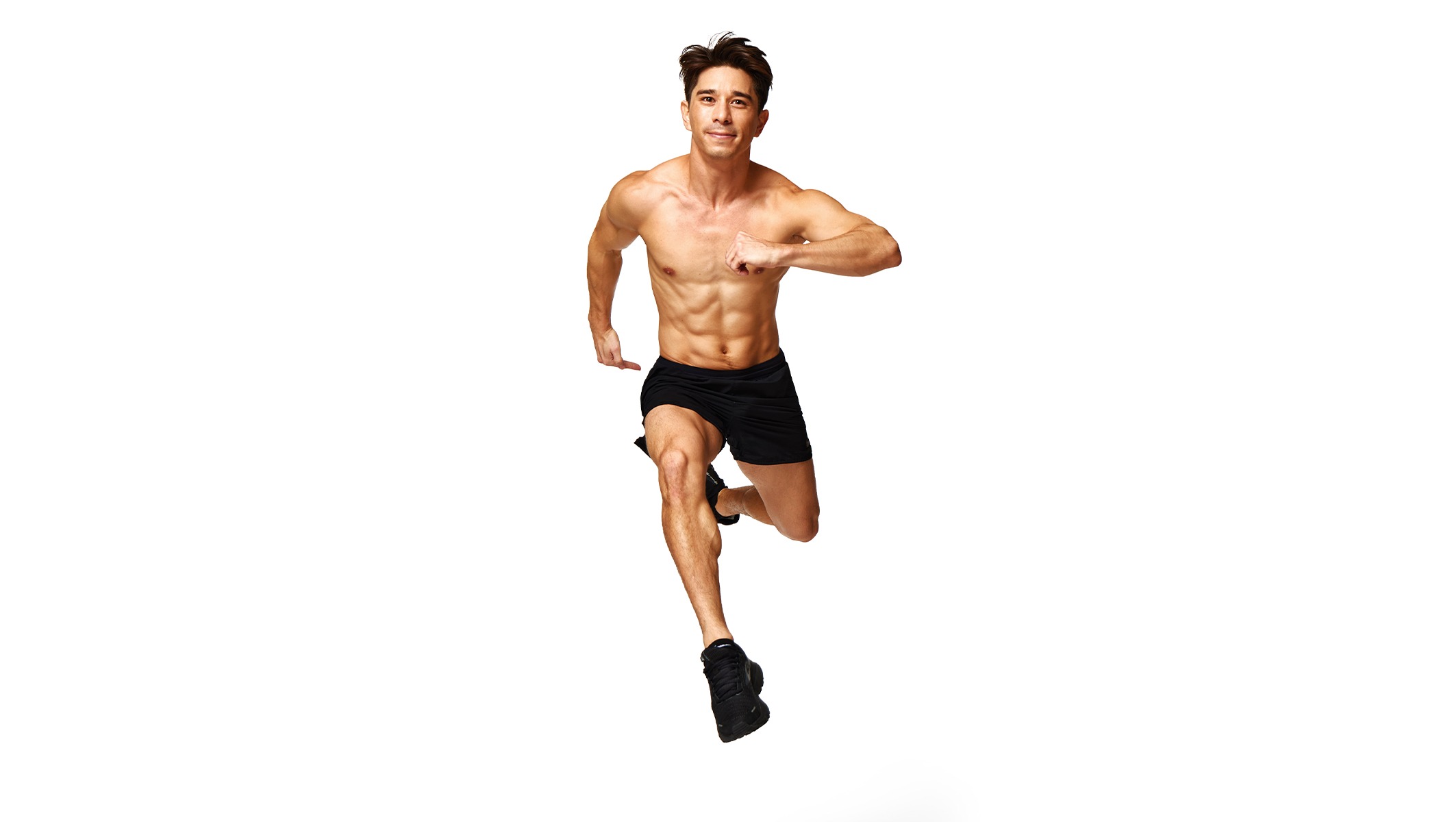 Barry’s instructor shirtless with black shorts running towards the camera against a white background