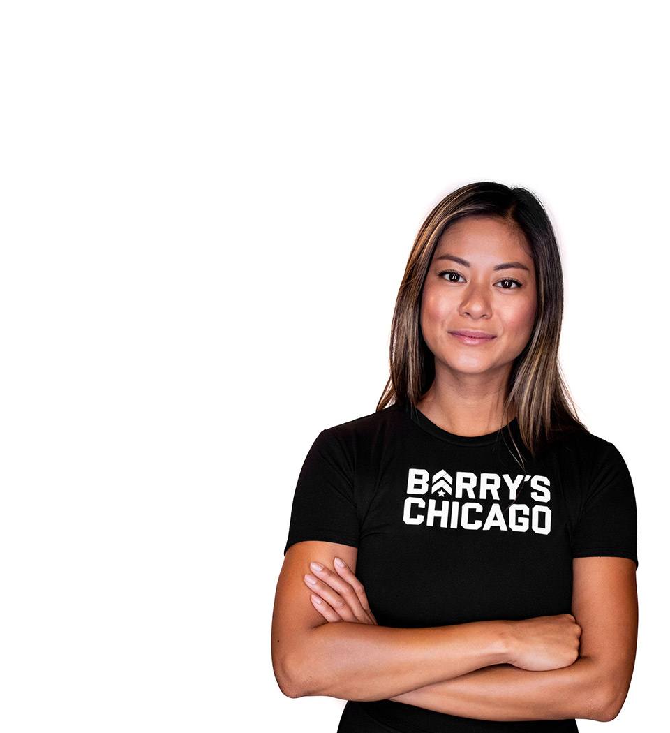 Barry's instructor standing confidently wearing a black top against a white background.