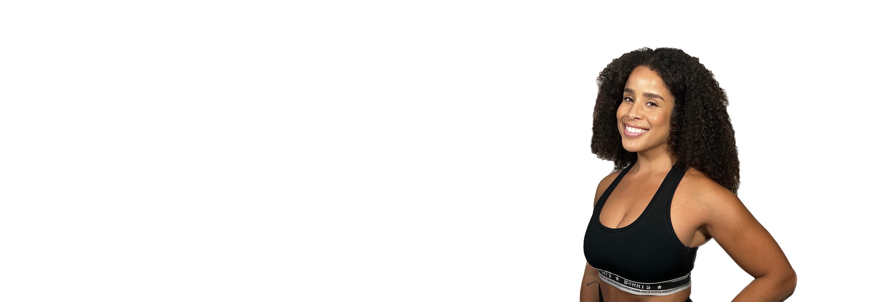 Barry's instructor standing confidently wearing a black top against a white background.